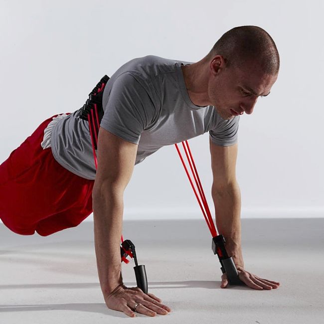 The work required for push ups can be easily increased using resistance bands without raising the legs higher.